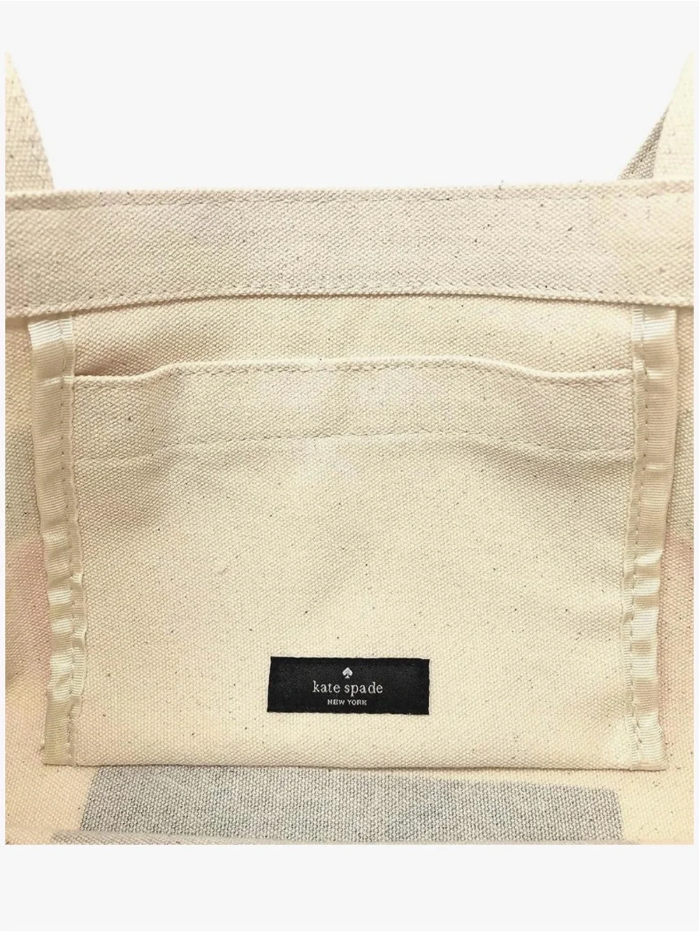 kate spade cream canvas tote with colorful book stack print